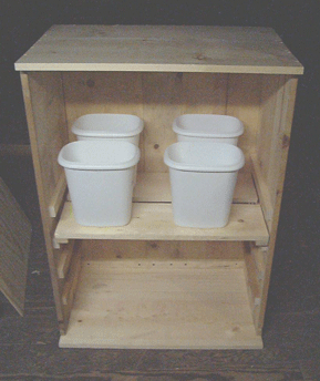 I have been working on this rough box since the seeds were planted.  The plants started under compact fluorescents, soon to be moved into this growbox with a 400W HPS.  I still have to paint the inside white, hang the door, mount the light, etc., but that will all be done soon enough.  I'm using small waste buckets instead of plastic pots this time because they take up less room and I'm not going to grow the plants as big this time.  